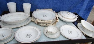 lot 318 image: Nortake China HOLBROOK  Place setting for 7 plus serving dishes- Soup tureen, gravy set, dinner plates, salad plates tea cups & saucers, soup bowls, dessert bowls bread plates and 2 fruit design milk glass glasses