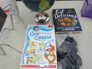 lot 334 image: Mini globe.  Eat delicious cook book.  bag of black sunglasses,   Ora, CEASUL
