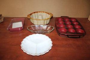 lot 61 image: Kitchen Lot Pampered Chef Ceramic Bundt Cake Mold, Silicone Muffin and Rack, Curtis Stone Bakeware (unopened) and Relish Dishes