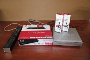 lot 130 image: Unopened LG Blu-Ray Disc Player, Apex DVD Player, 2 Personal 2-way Radios, and Surge Protector