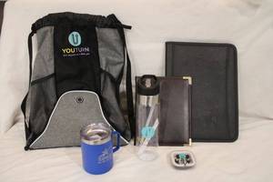 lot 206 image: You Turn branded backpack, water bottle (new), earplugs (new), portfolios and more