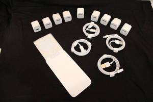lot 207 image: iPhone charging wires (4) and plugs (9). Also includes a pack of iPhone apple logo stickers, white. (2) cords are USB to USBC and (2) are USBC to Lightning cord