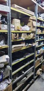 lot 519 image: Contents of Shelf. Gaskets, Seat Belt Kits, Fire Extinguisher, Trailer Tongues, Trailer Hitches, Couplers & MUCH MORE.  SHELF NOT INCLUDED  THIS ITEM MUST BE PICKED UP WEDNESDAY OR THURSDAY