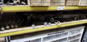 lot 530 image: Contents of Shelf. Trailer Hitch Pins, Misc Parts, Super-Cushion Air Spring & More  THIS ITEM MUST BE PICKED UP WEDNESDAY OR THURSDAY