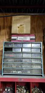 lot 546 image: Plastic 23-Drawer Parts Bin.  Contents Included.  Bolts Washers & Boxes of Screws Above Bin.
