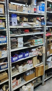 lot 489 image: Contents of Shelf - Hardware, Fiberglass Repair, Carpet Tape, Sanding Discs, and More - Shelf NOT Included  THIS ITEM MUST BE PICKED UP WEDNESDAY OR THURSDAY