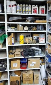 lot 670 image: Contents of Shelf.  Dolly Wheels, Fire Extinguishers, Coolant & Injector Cleaners, Oil Filters, Straps & More.  Shelf Not Included.  THIS ITEM MUST BE PICKED UP WEDNESDAY OR THURSDAY