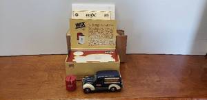lot 1073 image: Wix Diecast 1939 Chevrolet Canopy Van & Replica Wix Filter Bank w Box & Paperwork