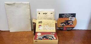 lot 1075 image: Wix Diecast 1939 Chevrolet Canopy Van & Replica Wix Filter Bank w Box, Paperwork & Poster