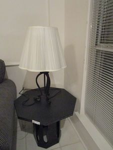 lot 25 image: BLACK OCTOGON SIDE TABLE AND LAMP
