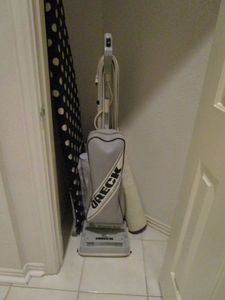 lot 26 image: CONTENTS OF CLOSET, ORECK VACCUUM, IRONING BOARD, MATS