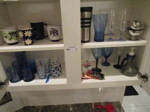 lot 57 image: CONTENTS OF 2 SHELVES, END TO END. COFFEE MUGS, COBALT BLUE GLASSES AND MORE