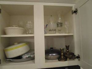 lot 62 image: CONTENTS IN CABINET ABOVE FRIDGE, VINTAGE FOOD CONTAINERS, BOWLS WITH HOLLY, CANDLE STICK HOLDERS FROM INDIA, COKE GLASS IN DIFFERENT LANGUAGES AND MORE
