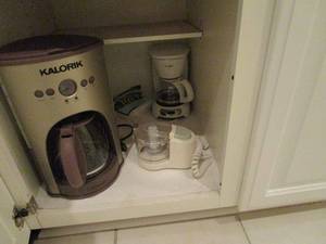 lot 77 image: CONTENTS OF CABINET, KALORIK COFFEE MAKER, COFFEE GRINDER, SMALL COFFEE MAKER