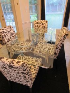 lot 129 image: IKEA&nbsp HENRIKSDAL DINING CHAIRS AND PATTERNED SLIP COVERS, GLASS TOP METAL BASE DINING TABLE