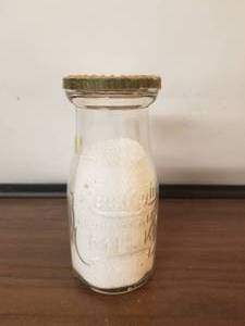 lot 54 image: Rawleich Farms half pint glass bottle with lid