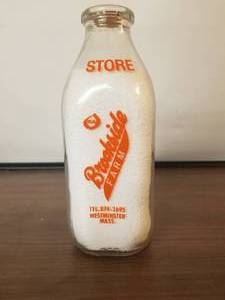 lot 67 image: Brookside Farm - Westminster, Mass. glass quart milk bottle with lid