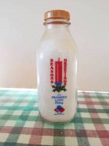lot 8 image: Promised Land Dairy -Floresville, Texas - Seasons Greeting glass quart milk bottle with lid