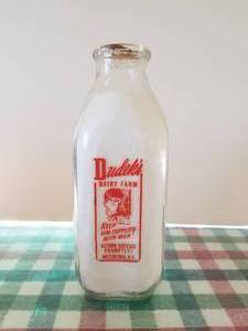 lot 13 image: Dudeks Dairy Farm -Waterford, New York - quart glass milk bottle (dual colors) with lid
