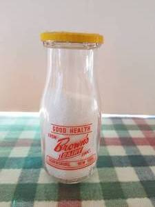 lot 19 image: Browns Dairy -Ogdensburg, New York - 12 pint glass milk bottle with lid