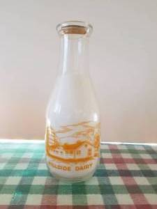 lot 21 image: Hillside Dairy quart size glass milk bottle with lid