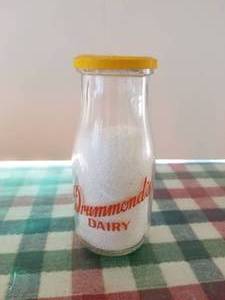 lot 39 image: Drummonds Dairy 12 pint glass milk bottle with lid