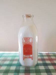 lot 68 image: Gulf Hills Farms quart glass milk bottle with lid