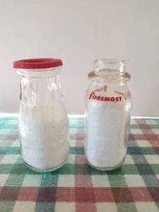 lot 67 image: Lot of 2 12 pint glass milk bottles, 1 is Foremost and Dairylea with lid