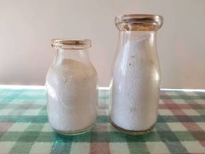 lot 85 image: Lot of 2 - 12 pint glass milk bottles, 1 is Sheffield and both have lids