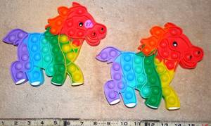 lot 87 image: PAIR OF HORSE THEMED POPPABLES