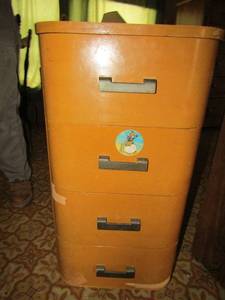 lot 16 image: Vintage Art Deco Haywood Wakefield style maple veneer side tables with black (Bakelite) handles Stamped TLO-  Flexible Furniture, c1940s approx   4 Drawers  32x16x20  Veneer needs repair