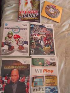 lot 35 image: Wii games- Deal or no deal, Wii play Mario Cart, Country dance x 2 Sugarland, Darious Rucker