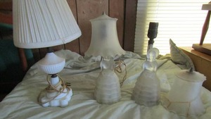lot 52 image: Two frosted glass hoop skirt lamp bases   1 shade is cracked 12 tall and milk glass lamp 15