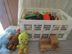 lot 106 image: White tote full of legos, 3 stuffed animals and 1 wooden truck