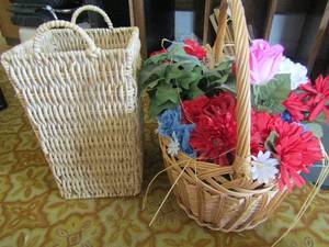 lot 150 image: 2 wicker baskets- one with Red, white and blue flowers the other without LOL