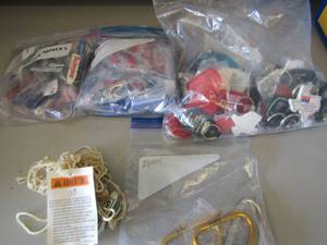 lot 36 image: 3 zip lock bags full of key chains and bottle openers