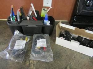 lot 63 image: Black caddy with pens and pencils, flash light, air freshener and more 2 NIP cable assembly cords and box of black chip clips
