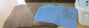 lot 70 image: CONTAINOR  full of brown and blue no slip rugs