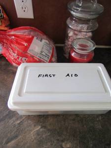 lot 95 image: Bag and jar of peppermints, new cinnamon candle, first aid tub
