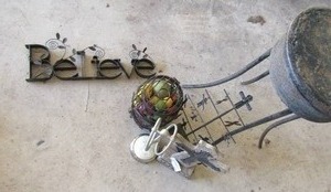 lot 217 image: Black metal plant table, metal BELIEVE sign, metal jug, crosses