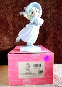 lot 58 image: PRECIOUS MOMENTS DATED 2002 FIGURINE104202MAY YOUR HOLIDAYS SPARKLE WITH JOY