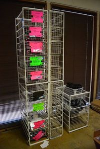 lot 559 image: Elfa Basket Storage Racks, 3 Racks one holds 10 Baskets, one holds 10 narrower baskets, one holds 3 wider baskets CONTENTS SOLD SEPARATELY