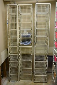lot 571 image: Elfa Basket Storage Racks, 3 Racks, 2 hold 10 Baskets, Narrower one holds 10 Baskets CONTENTS SOLD SEPARATELY