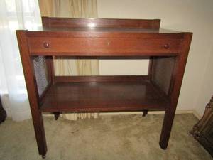 lot 4 image: Mid Century Modern Wood w Wicker inserts  Beautiful wood rolling bar top table- 1 drawer, bottom storage, wicker sides   40 x 40 x 20  matches 48, 62, 118