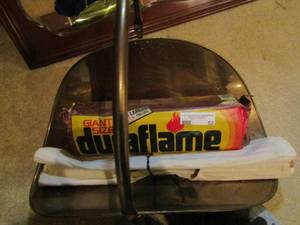 lot 52 image: Brass wood holder with Dura flame fire log and cloth wood carrier