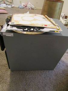 lot 74 image: 2 drawer file cabinet, 3 yard American flags, Fall window stickers and tin wall plates