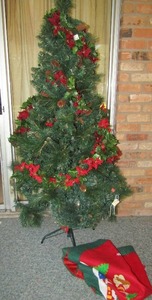 lot 99 image: Six foot tall lighted christmas tree with skirt