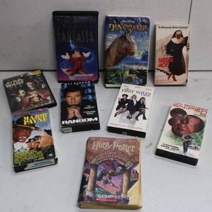 lot 247 image: VHS Movies and Harry Potter Book The Socerers Stone