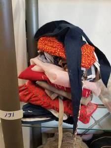 lot 131 image: Selection of Bonnets and aprons