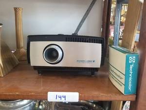 lot 144 image: Bausch & Lomb projector and a Yogi Bear tape for projector